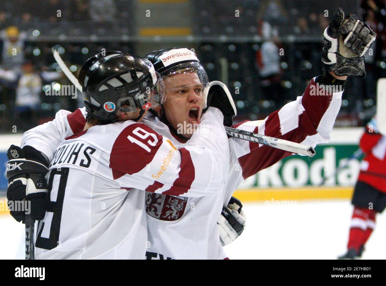 Latvia's Guntis Dzerins (R) celebrates his goal against Austria with  Mikelis Redlihs during their IIHF World Hockey Championship game in Bern,  April 29, 2009. REUTERS/Petr Josek (SWITZERLAND SPORT ICE HOCKEY Stock  Photo -