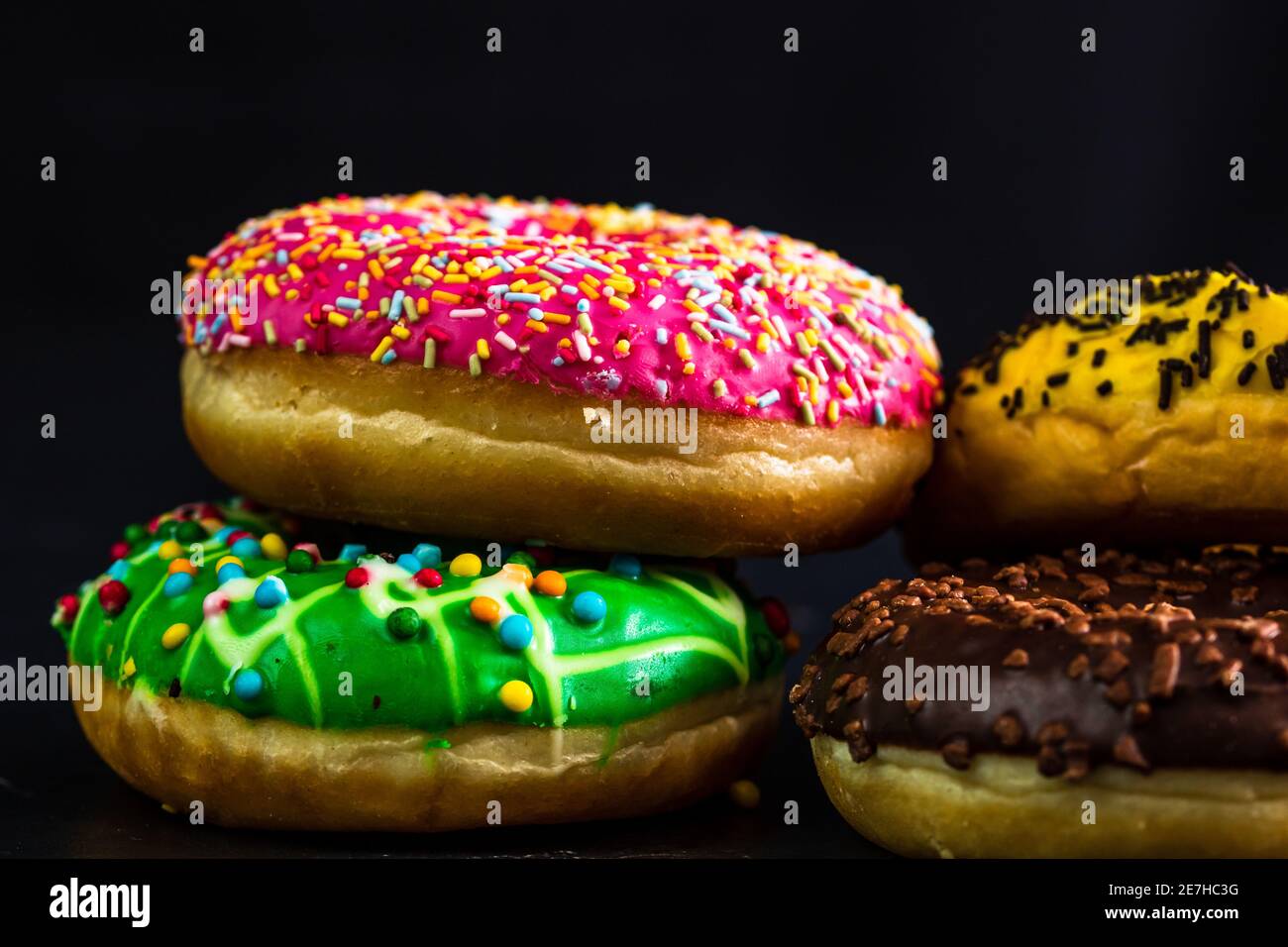 Glazed donuts with sprinkles isolated. Close up of colorful donuts ...