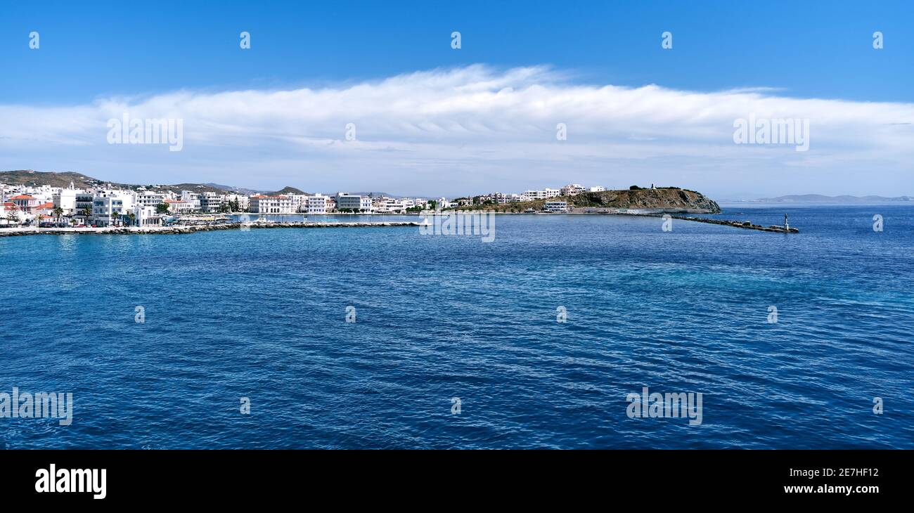 Panoramic sea view of main town of Tinos island and its harbor, Greece. Beautiful summer day, azure sea, vacations, Mediterranean island hopping. Stock Photo