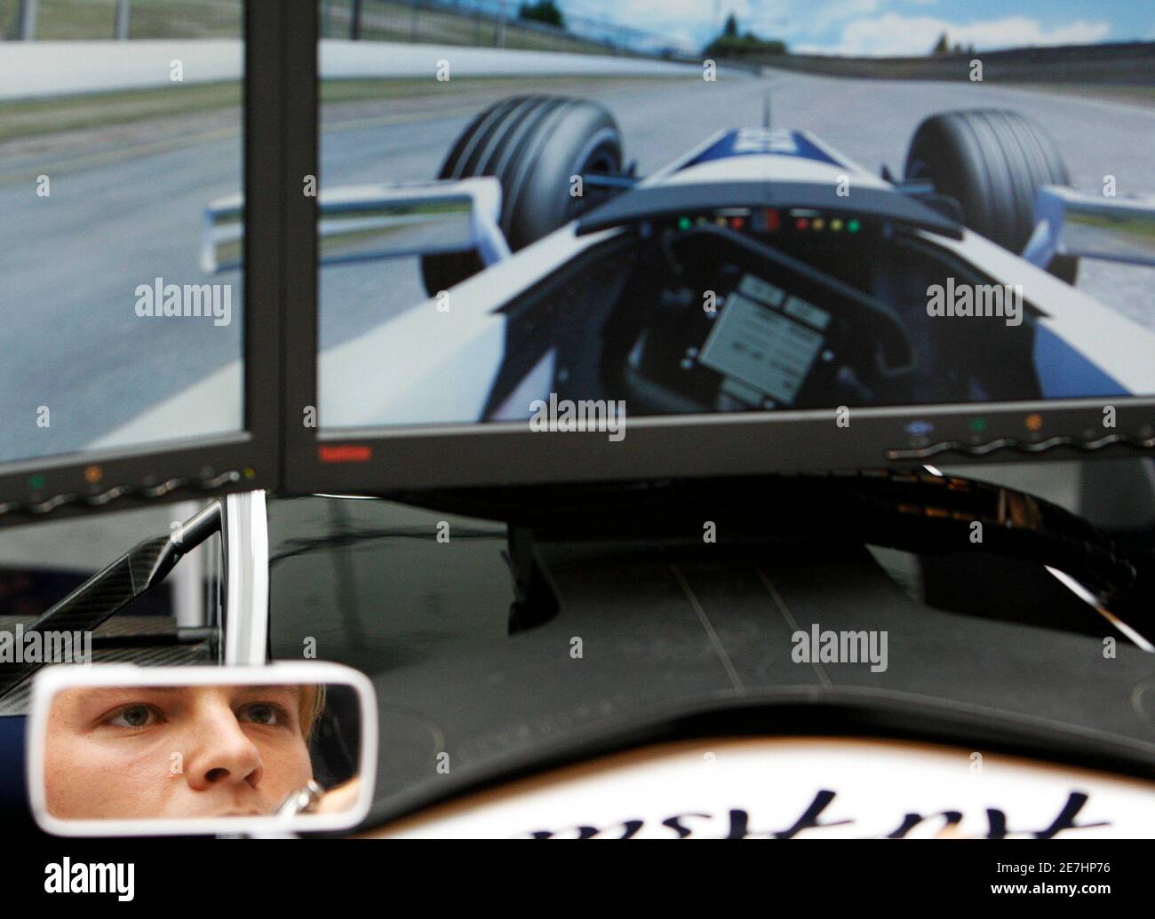 Williams Formula One driver Nico Rosberg of Germany is reflected in a wing mirror as he drives an F1 simulator in Singapore March 18, 2008.  REUTERS/Vivek Prakash (SINGAPORE) Stock Photo