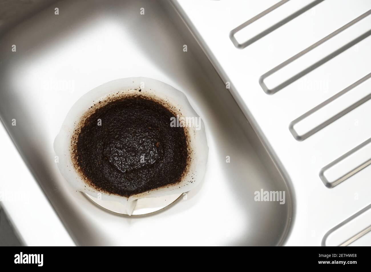 Coffee filter paper draining in kitchen sink plughole Stock Photo Alamy