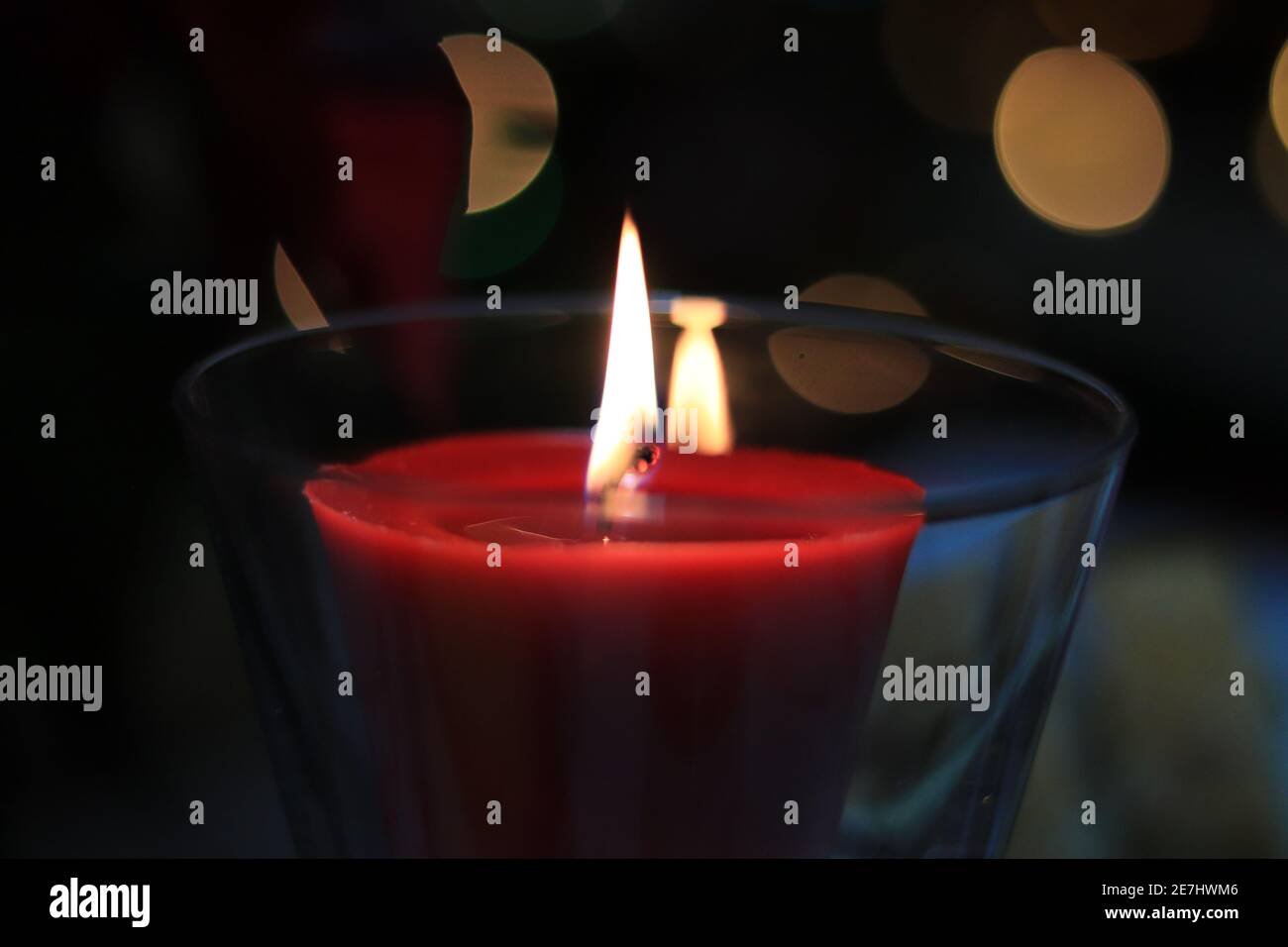 red candle flame at night with lights in background Stock Photo Alamy