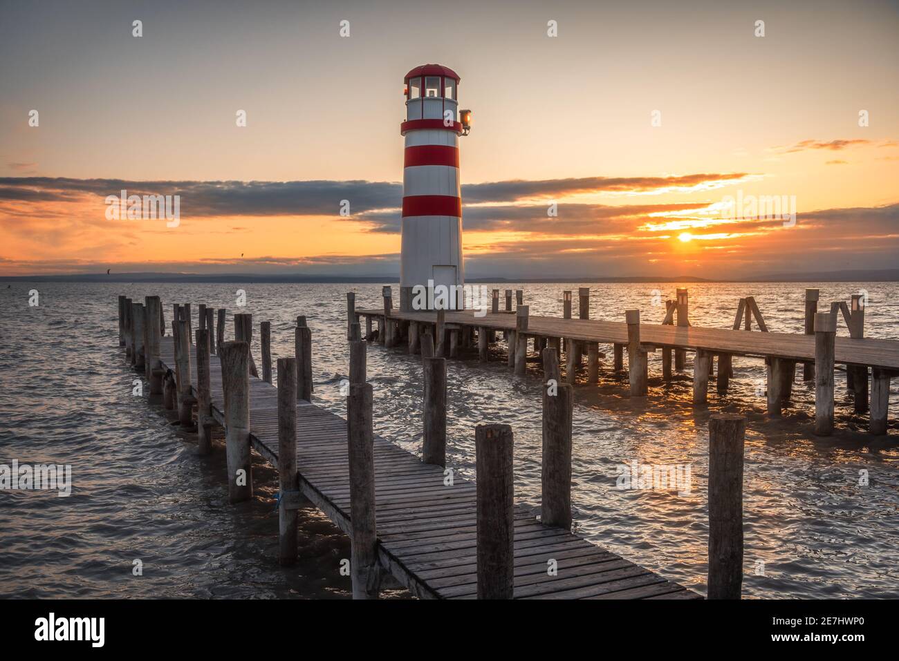 Wooden Pier Floor under Lighthouse on Neusiedl Lake, Austria at Sunset Stock Photo