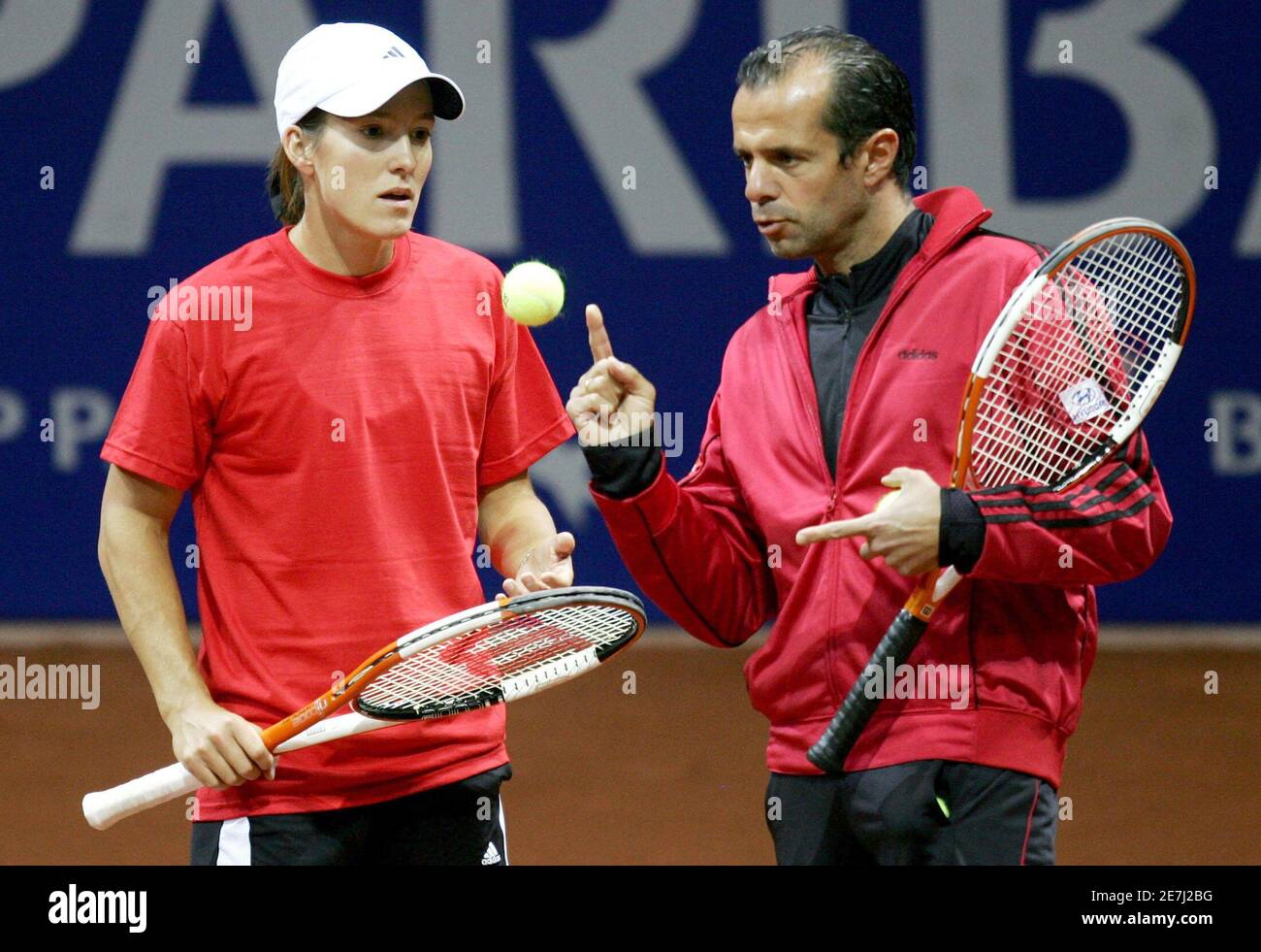 Belgium's Fed Cup tennis player Justine Henin-Hardenne listens her coach  Carlos Rodriguez (R) during a training session in Liege April 21, 2006.  Belgium will play Russia in the Fed Cup quarter-finals. REUTERS/Francois