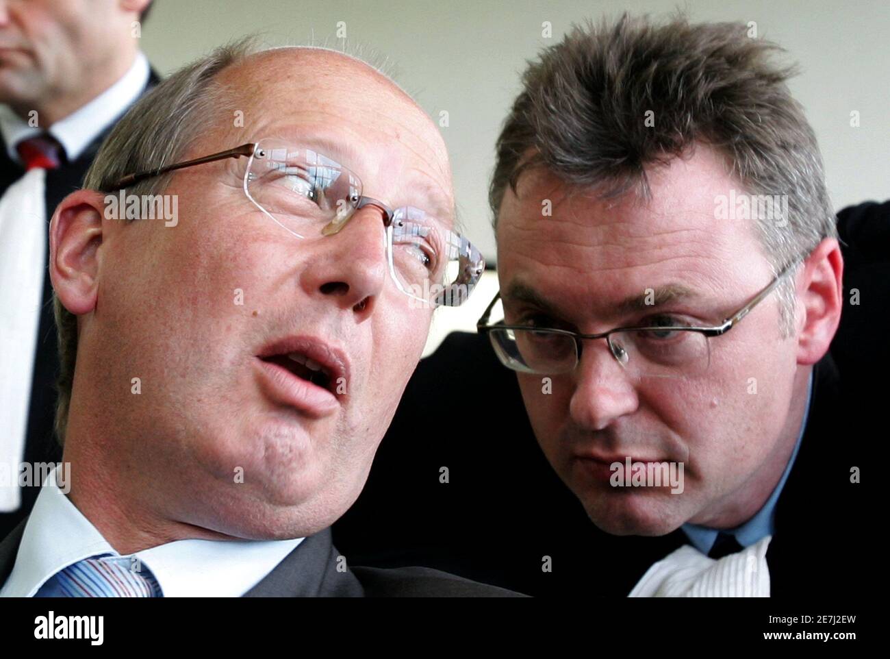 G14 General Manager Thomas Kurth (L) talks to his lawyer Jean-louis Dupont  in a courtroom in Charleroi May 15, 2006. A Belgian court referred on  Monday a case taken against soccer's governing