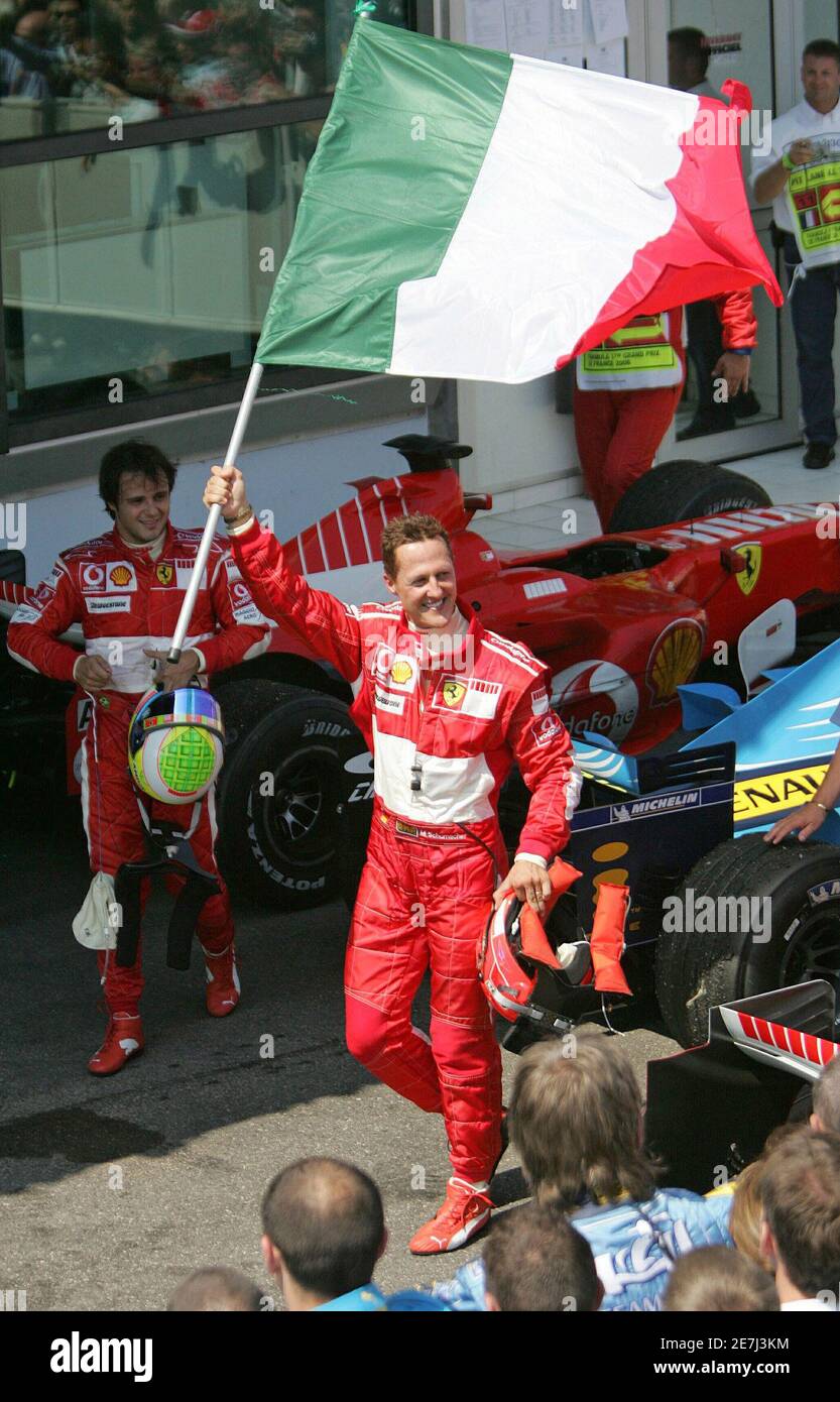 Ferrari's Formula One driver Michael Schumacher of Germany celebrates with the Italian flag after his victory at the French Grand Prix at Magny-Cours July 16, 2006. Stock Photo