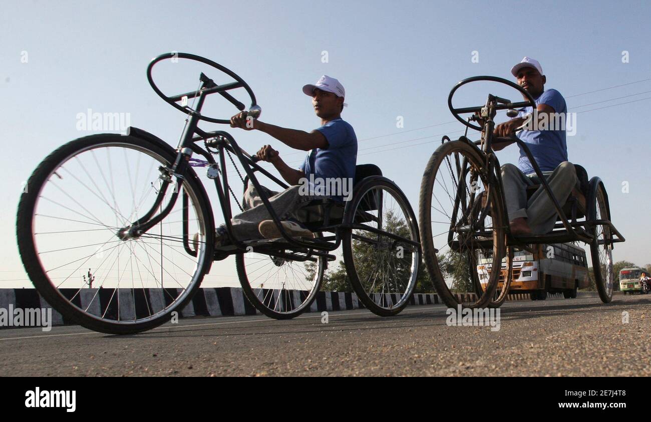 Physically handicapped men ride their tricycles during a tricycle marathon  race in the western Indian city of Ahmedabad February 11, 2007. Hundreds of  physically handicapped men from different parts of India on