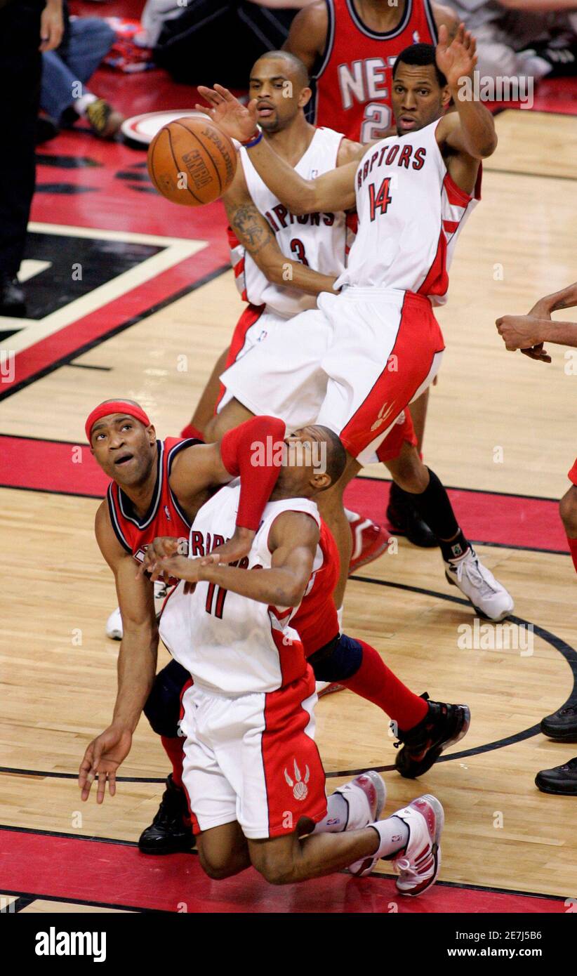 New Jersey Nets' Vince Carter (L) battles for the ball with Toronto Raptors' T.J. Ford (11), Joey Graham (14), and Juan Dixon during the first half of Game 5 in their NBA Eastern Conference Playoff basketball series in Toronto, May 1, 2007.     REUTERS/Mark Blinch  (CANADA) Stock Photo