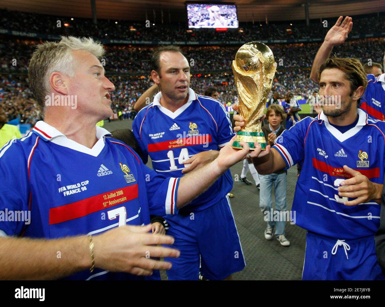 France S Didier Deschamps L Alain Boghossian C And Bixente Lizarazu Hold The World Cup Trophy After An Exhibition Soccer Match Between France S 1998 World Cup Champions And A Selection Of Players From