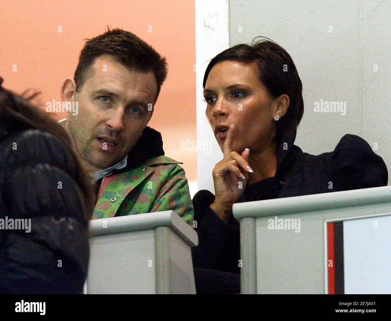 Victoria Beckham (R), wife of AC Milan's David Beckham, talks to a friend  before the start of the Italian Serie A soccer match between AC Milan and  Lecce at the San Siro