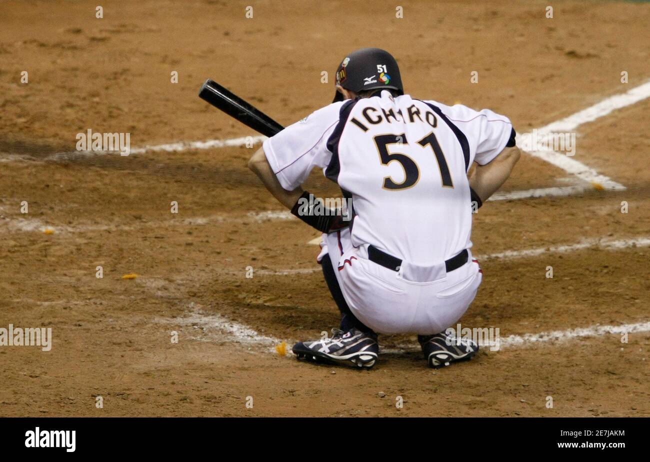 Japan's Ichiro Suzuki stretches as he steps into the batter's box in the  ninth inning during the World Baseball Classic (WBC) Tokyo round against  China in Tokyo Dome March 5, 2009. REUTERS/Issei