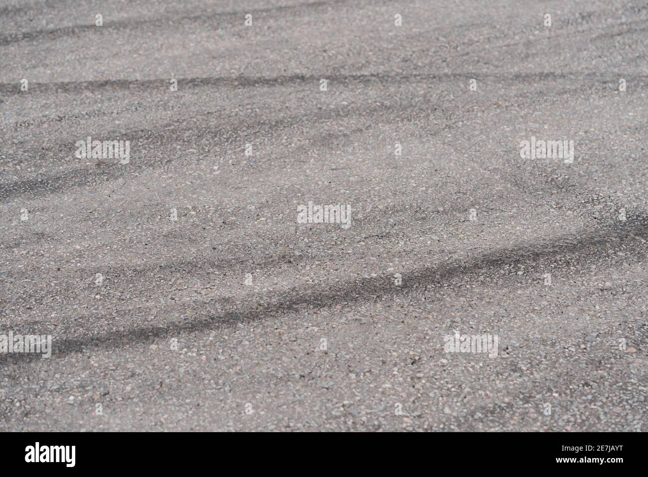 Asphalt with black rubber marks from tyres, abstract photo Stock Photo