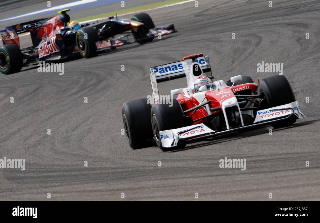 Toyota Formula One driver Jarno Trulli of Italy (R) drives ahead of Toro  Rosso Formula One driver Sebastien Buemi of Switzerland during the  qualifying session at the Bahrain F1 Grand Prix in