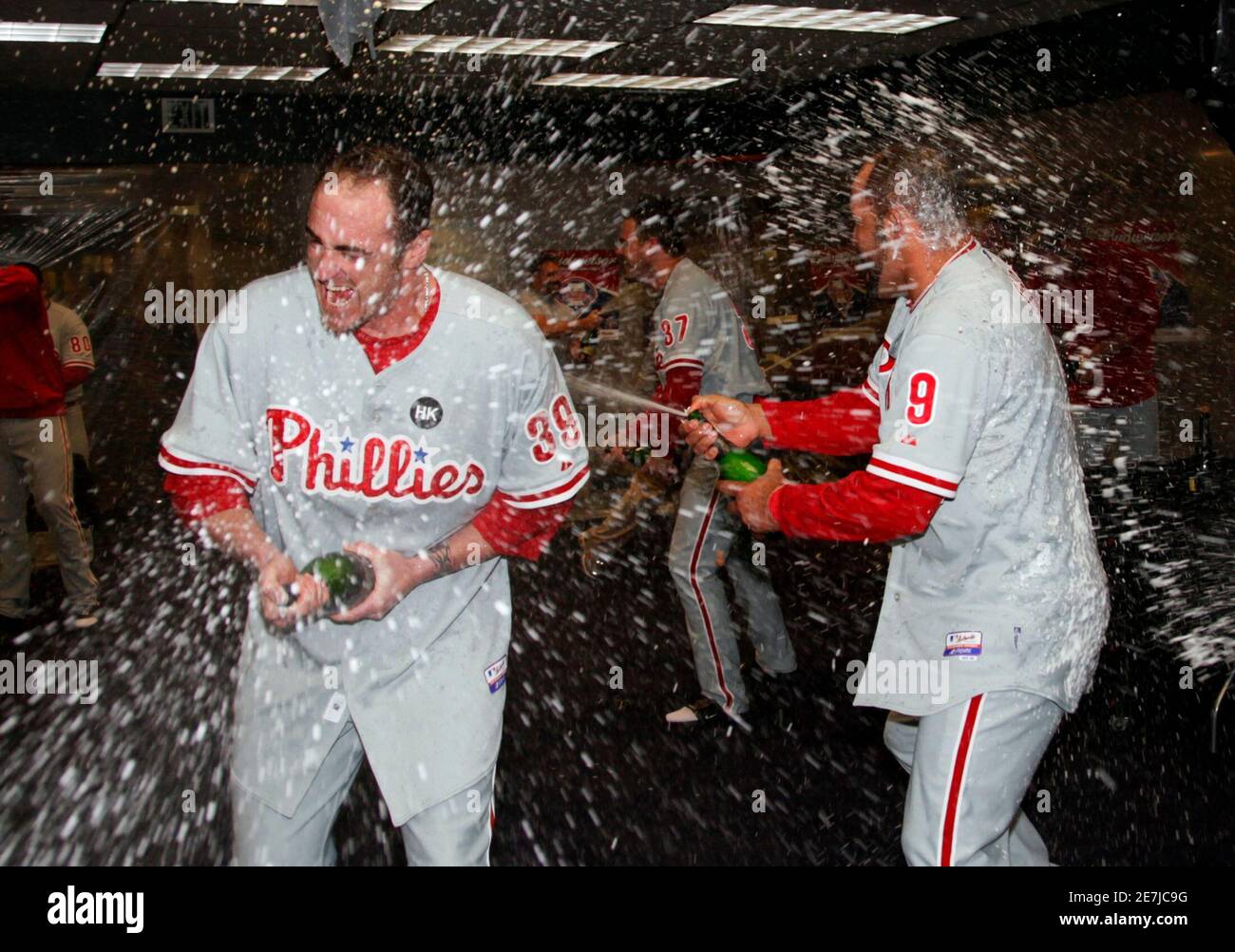 Philadelphia Phillies Brett Myers (L) and Miguel Cairo celebrate in the dressing room after the Phillies defeated the Colorado Rockies in their MLB National League Division Series playoff baseball game in Denver, October 12, 2009.     REUTERS/Rick Wilking (UNITED STATES SPORT BASEBALL IMAGES OF THE DAY) Stock Photo