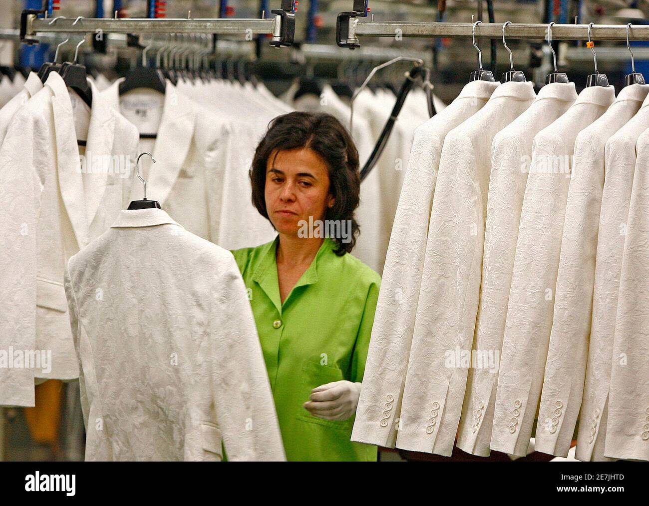 A woman works at the Zara factory at the headquarters of Inditex group in  Arteixo, northern Spain 29 March 2006. Spain's Inditex, owner of the Zara  fashion chain, [said on Wednesday it