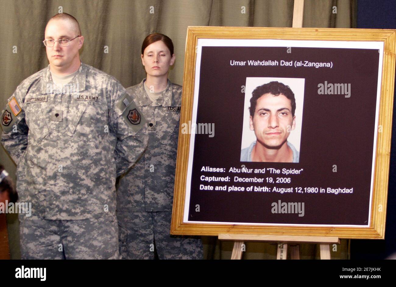 U.S soldiers stand near a picture of Umar Wahdallah Dad (al-Zangana) captured on December 19, 2006 during a media conference for Maj. Gen. William B. Caldwell IV, Multi-National Force-Iraq Spokesman and Brig. Gen. C. Mark Gurganus, Commanding General, Ground Combat Element, Multi-National Force-West, at the heavily fortified Green Zone area in Baghdad on May 16, 2007. REUTERS/Ali Abbas/Pool (IRAQ) Stock Photo