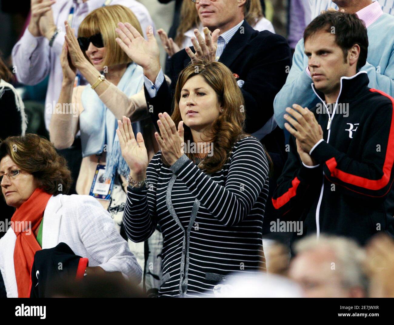 Roger Federer's wife Mirka, who recently gave birth to twin girls, stands  and applauds after her husband defeated Simon Greul of Germany during their  match at the U.S. Open tennis tournament in