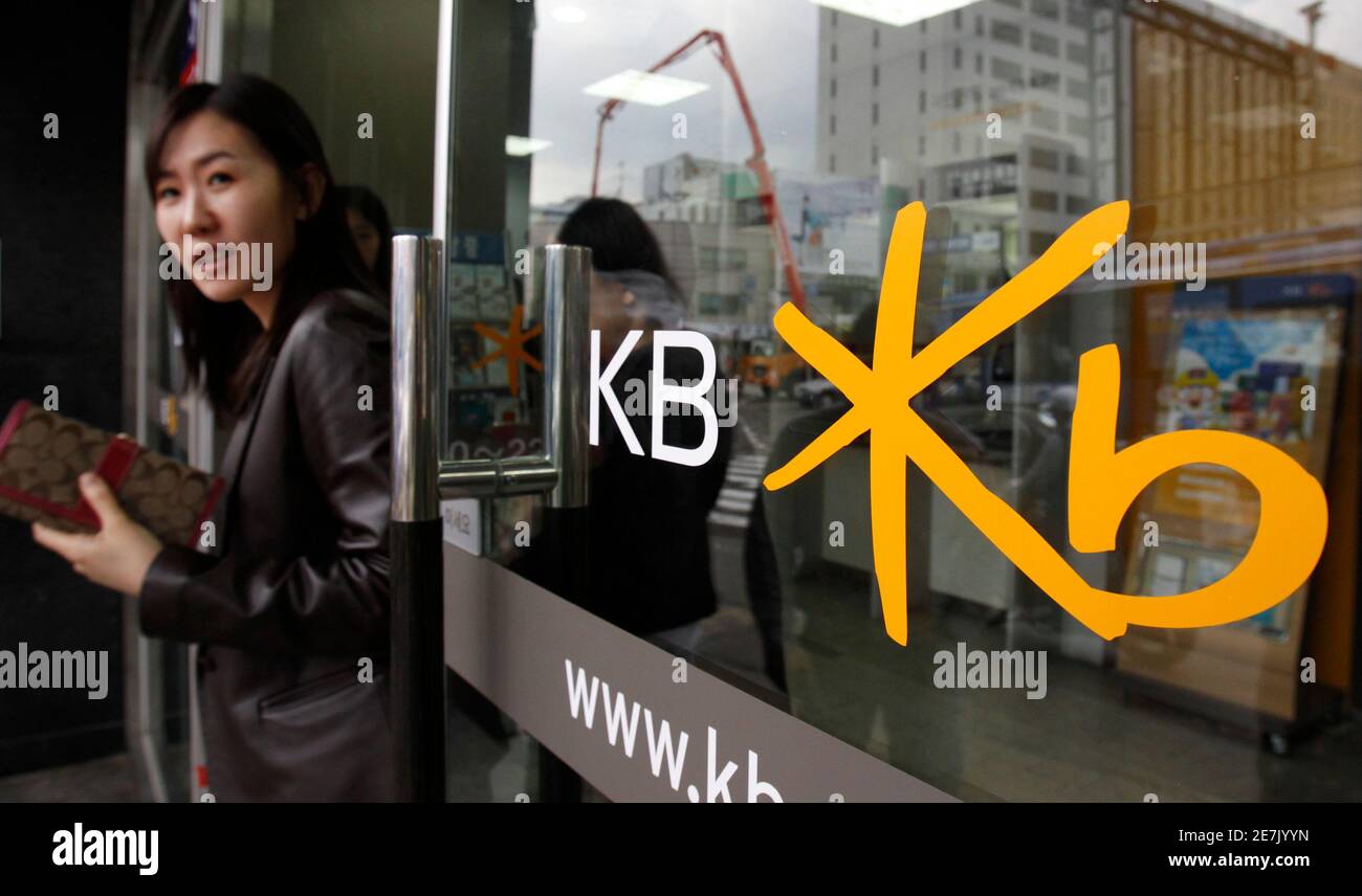 A customer walks out of a branch office of the Kookmin Bank in Seoul April 30, 2010. KB Financial Group, South Korea's No. 2 banking group by market value and the parent of top domestic bank Kookmin, reported the best quarterly profit in its near two-year history, beating forecasts, as interest margins expanded and provisioning burdens eased.  REUTERS/Jo Yong-Hak (SOUTH KOREA - Tags: BUSINESS) Stock Photo
