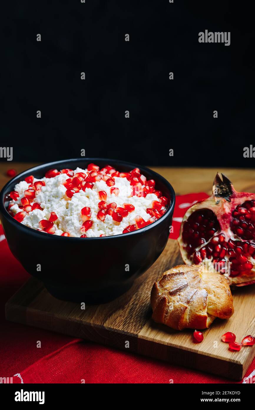 Cottage Cheese In Bowl. Homemade Curd Cheese Served With pomegranate seeds in a bowl. Healthy breakfast concept. Stock Photo