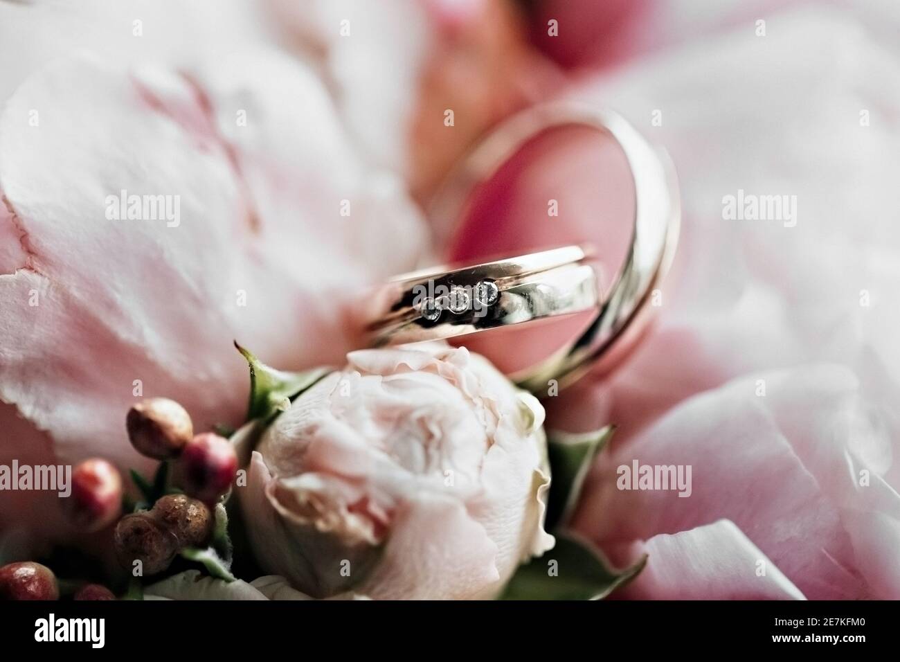 Wedding rings with a bouquet of flowers. Marriage proposal. Wedding. Stock Photo