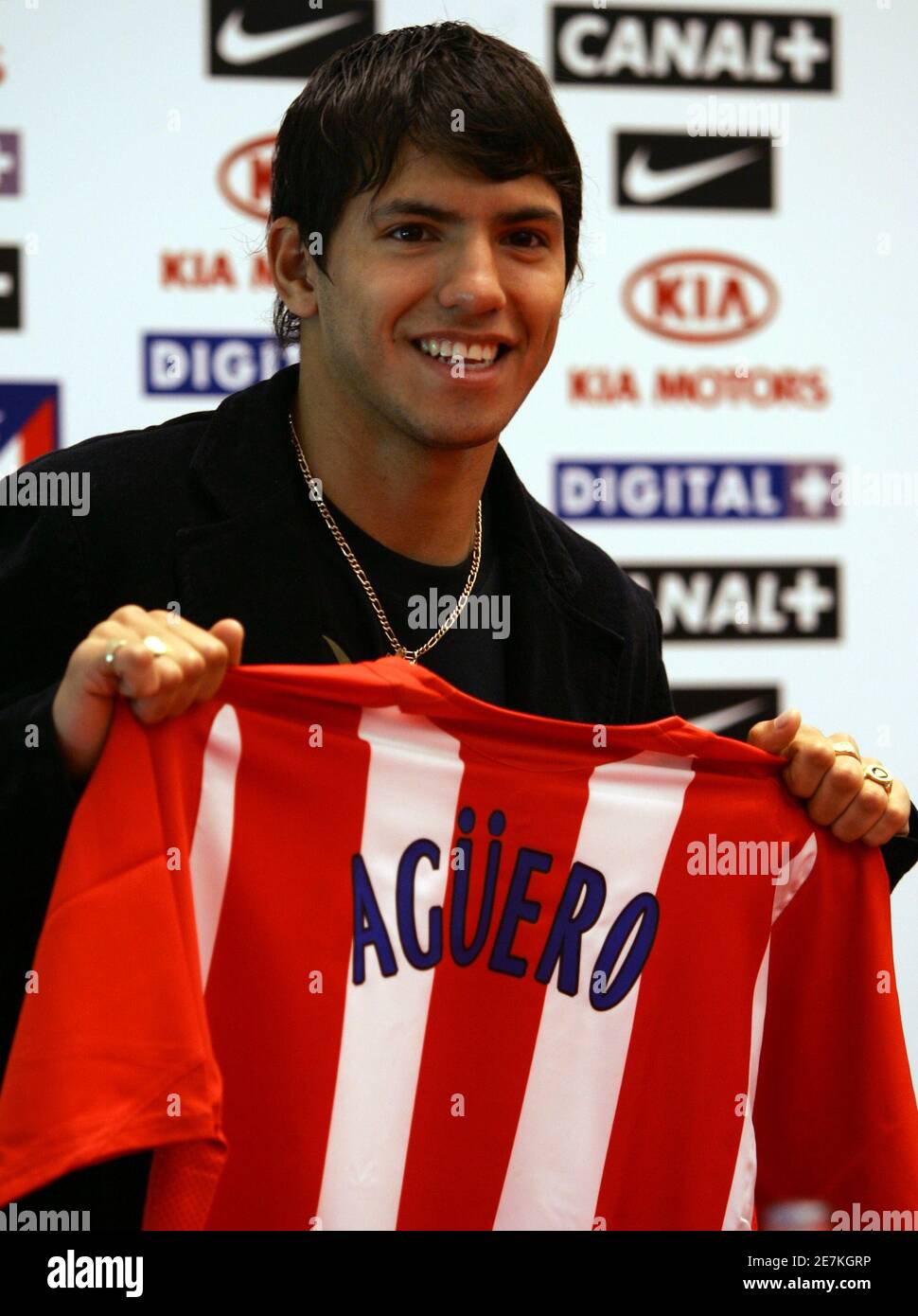 Atletico Madrid's new soccer player Sergio Aguero from Argentina holds his  new team jersey during his presentation ceremony at Vicente Calderon  stadium in Madrid June 5, 2006 after signing a six-year contract