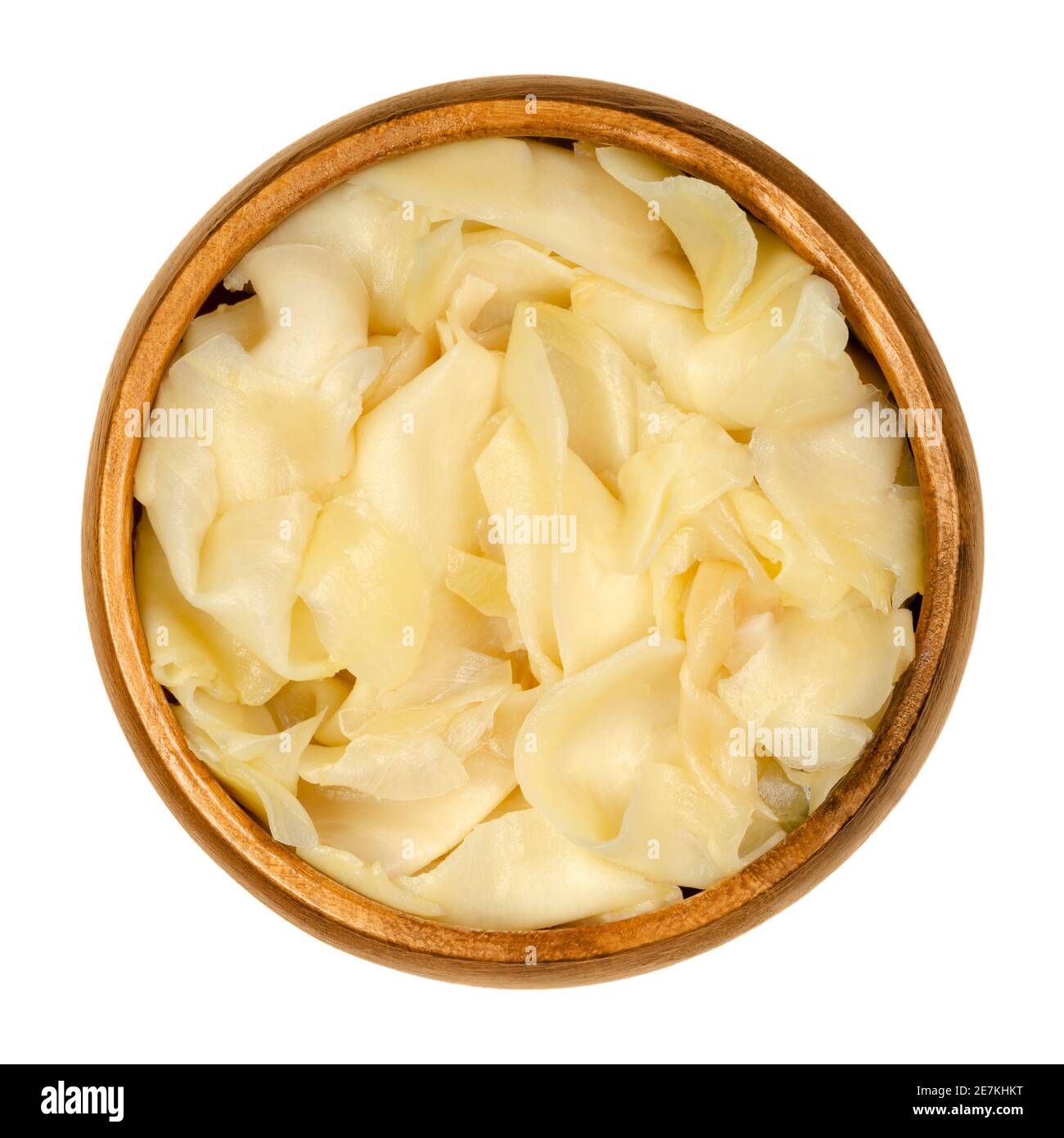 Gari, pickled ginger in a wooden bowl. Thinly sliced ginger, marinated in sugar and vinegar, served after sushi. The color is pale yellow or pink. Stock Photo