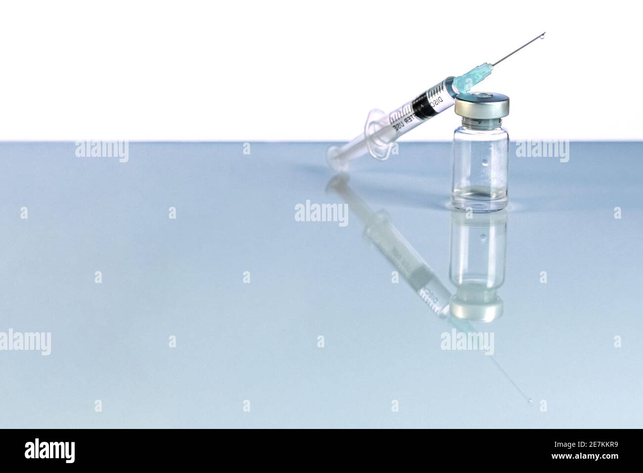 Syringe and vial with coronavirus vaccine, injection vial dose on a ...