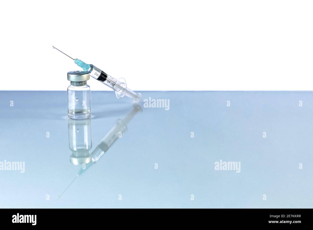 Syringe and vial with coronavirus vaccine, injection vial dose on a ...