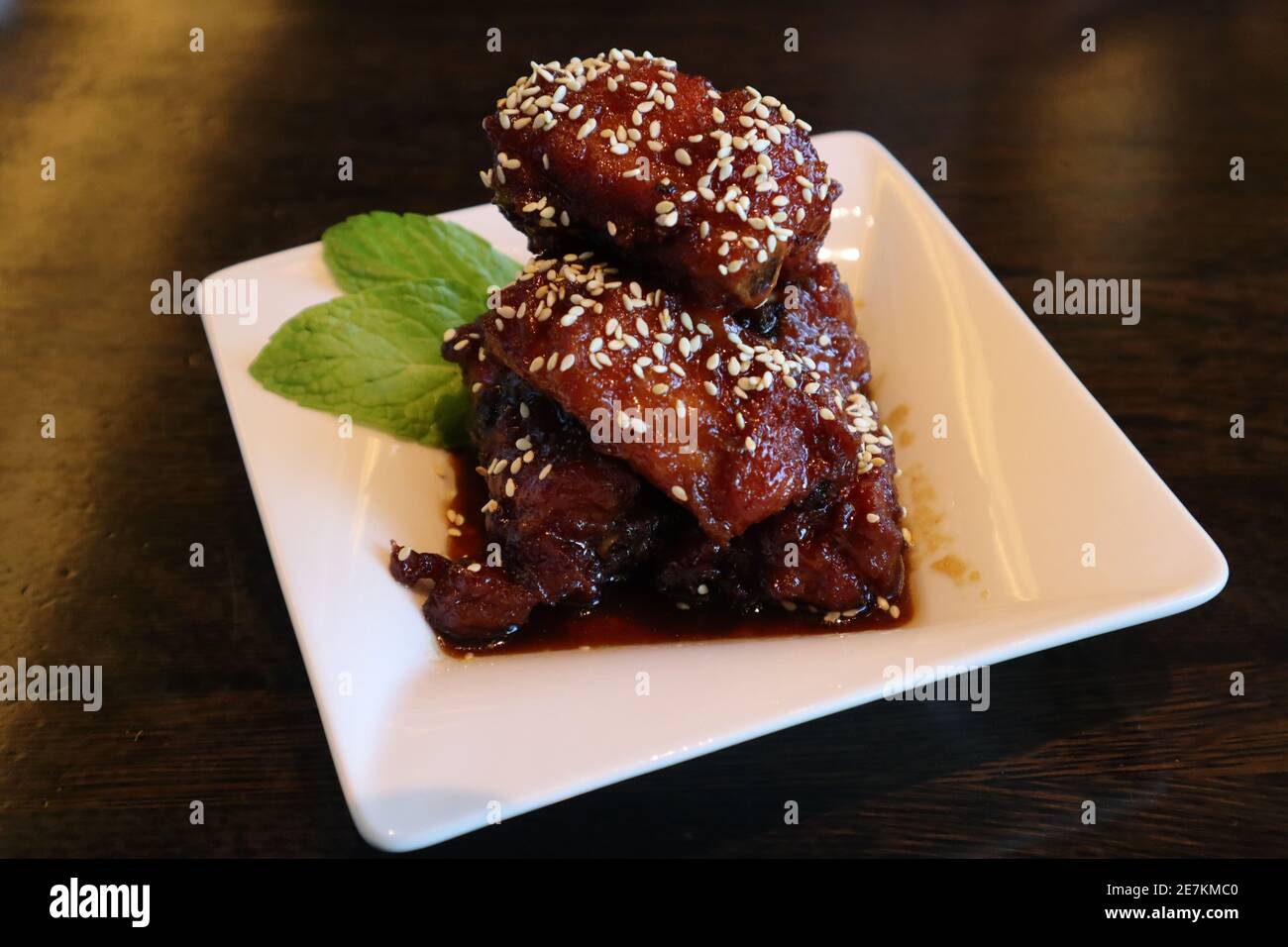 Closeup shot of a stack of pork spare ribs with sesame seed topping and