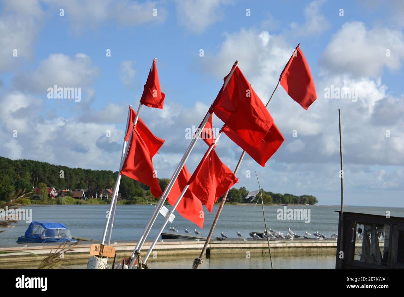 Red fishing flags group near sea Stock Photo
