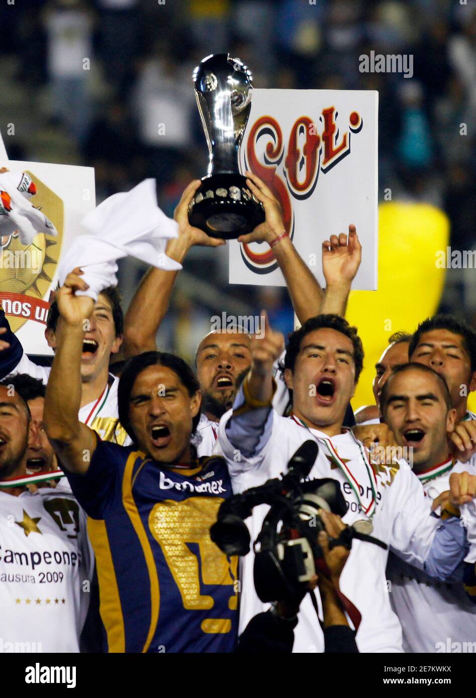 Pumas UNAM captain Sergio Bernal (C) holds the trophy after winning the  Mexican league championship soccer match final against Pachuca at Hidalgo  stadium in Pachuca May 31, 2009. REUTERS/Eliana Aponte (MEXICO SPORT