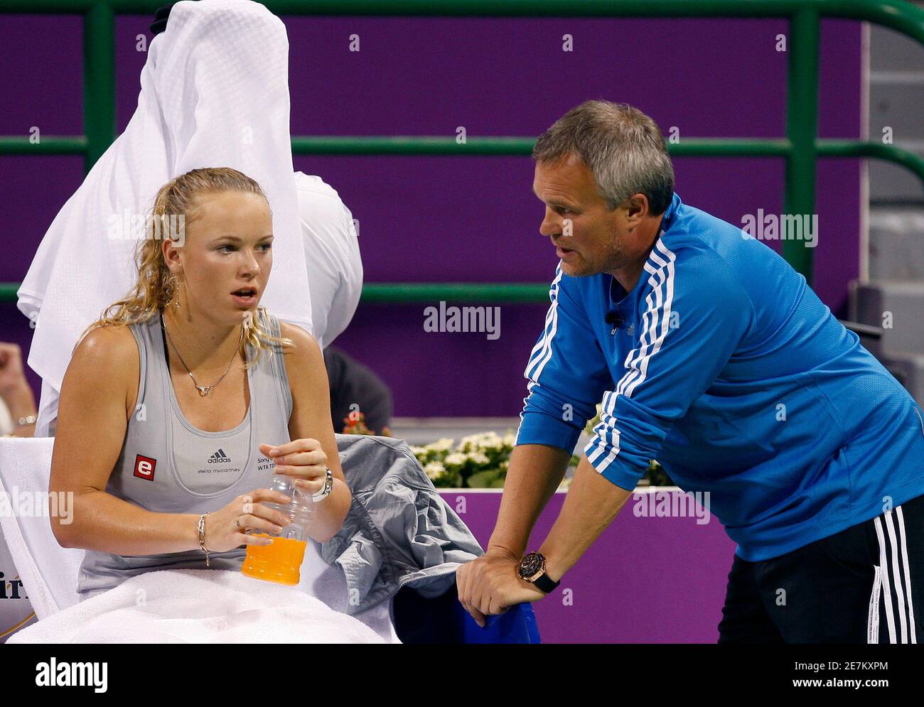 Caroline Wozniacki of Denmark listens to her coach and father Piotr during  her semi-final match against Serena Williams of U.S at the WTA Tour  Championships in Doha October 31, 2009. Wozniacki retired