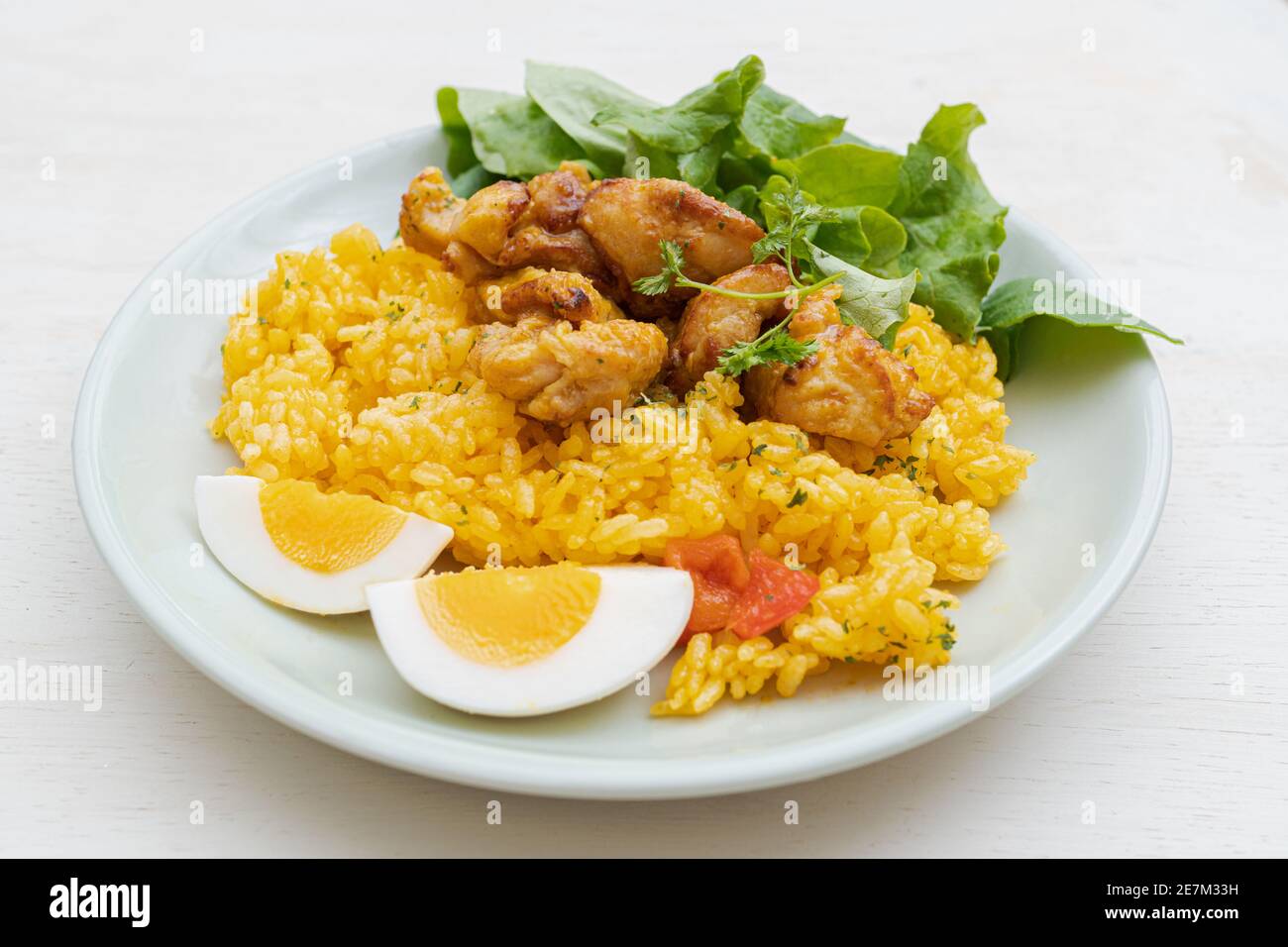 Chicken paella rice with boiled egg and salad Stock Photo Alamy
