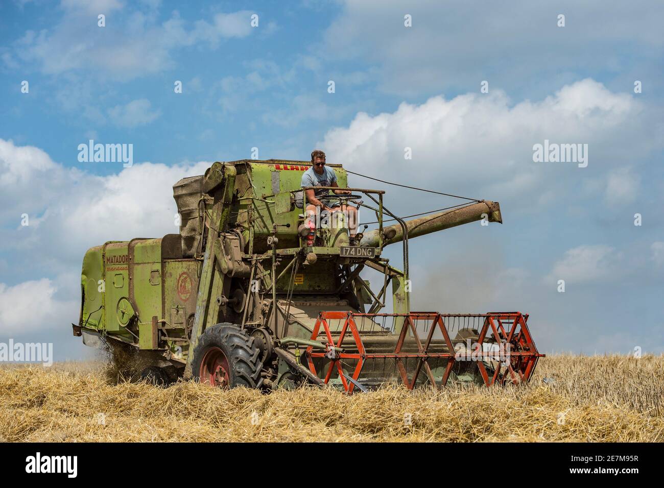 vintage claas matador combine harvester at work combining in the uk countryside Stock Photo