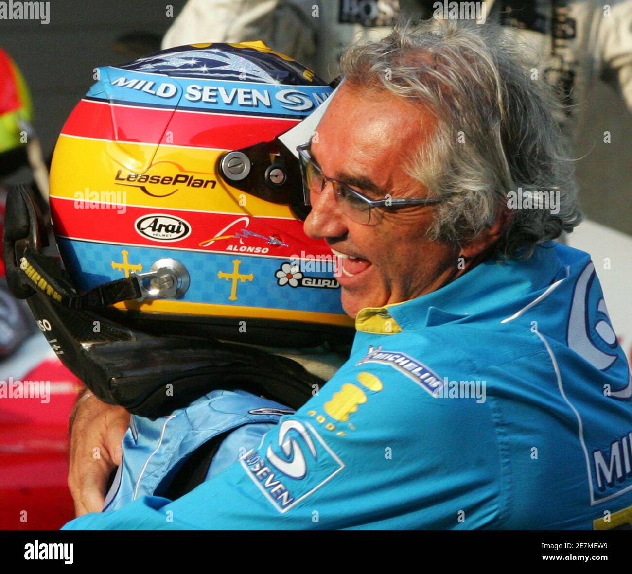 Renault's World Champion Formula One driver Fernando Alonso of Spain  celebrates with Renault F1 team Managing Director Flavio Briatore after  winning the season-ending Chinese Grand Prix in Shanghai October 16, 2005.  Alonso