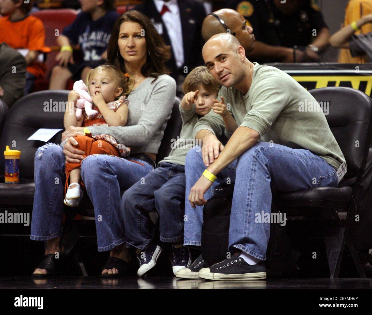 Tennis star couple Andre Agassi (R), his wife Steffi Graf (2nd L) and their  daughter Jaz Elle (L) and son Jaden Gil (2nd R), attend an NBA game between  the Miami Heat