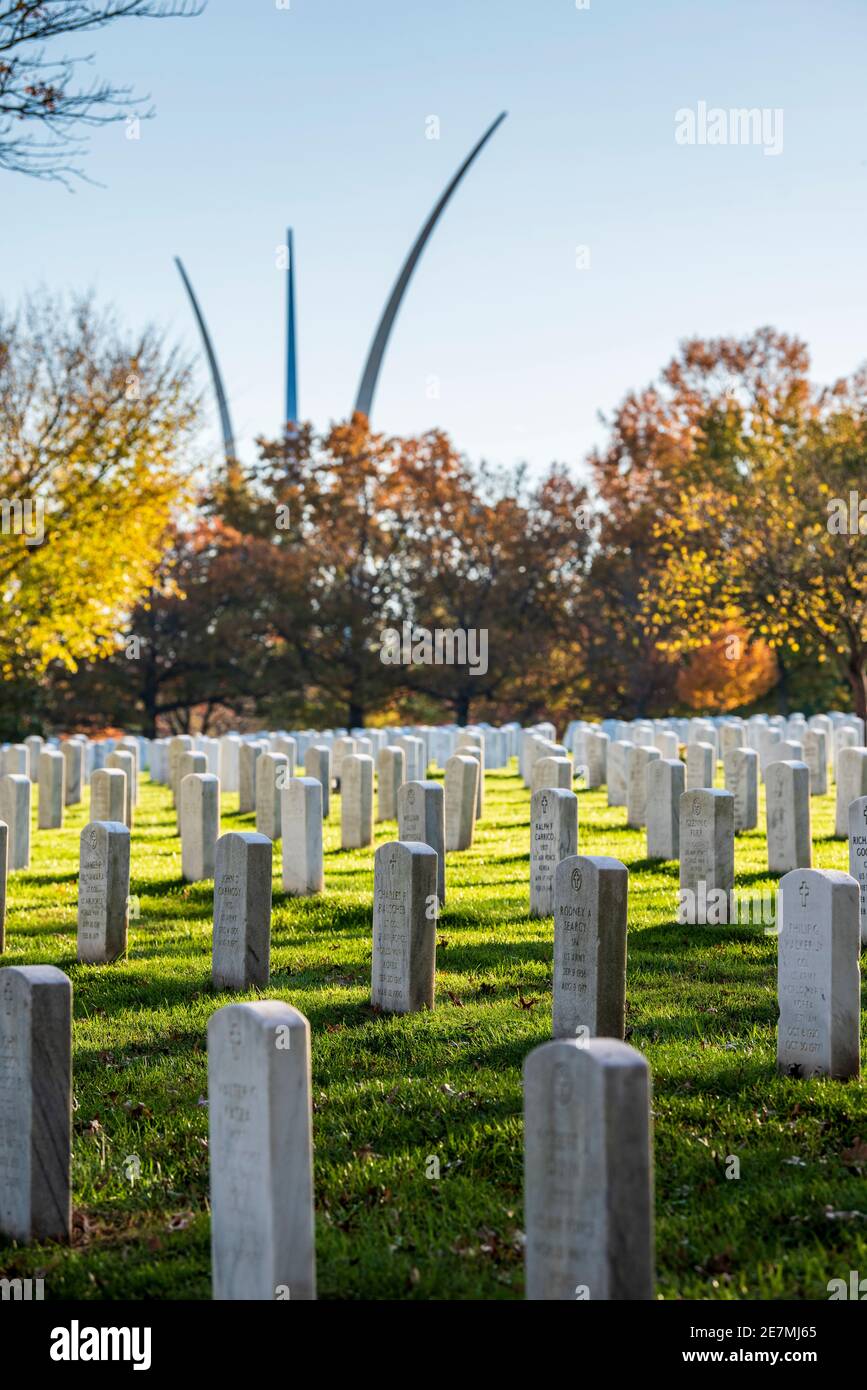 The silver spires of the United States Air Force Memorial rise up into the sky behind rows of graves at Arlington National Cemetery in Arlington, Virg Stock Photo