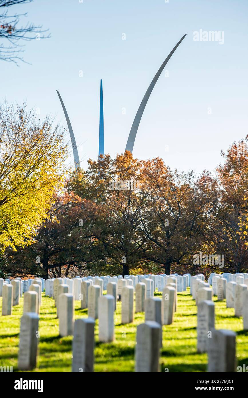 The silver spires of the United States Air Force Memorial rise up into the sky behind rows of graves at Arlington National Cemetery in Arlington, Virg Stock Photo