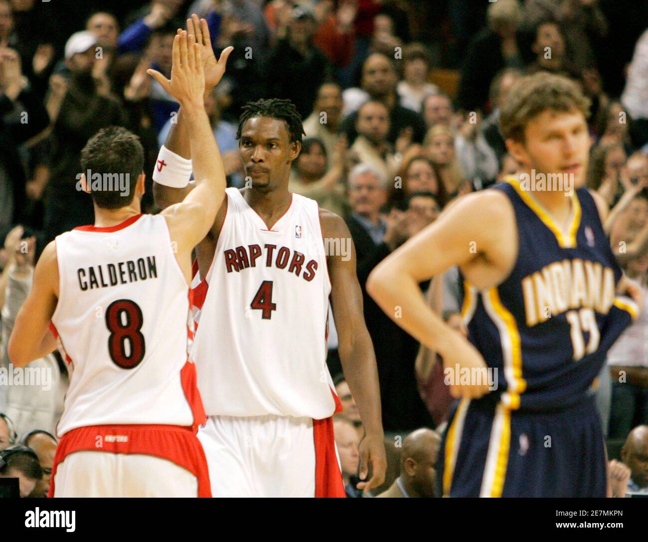 Toronto Raptors' Jose Calderon (L) and Chris Bosh (C) celebrate their win behind Indiana Pacers' Travis Diener during the fourth quarter of their NBA basketball game in Toronto November 16, 2007.     REUTERS/ Mike Cassese   (CANADA) Stock Photo