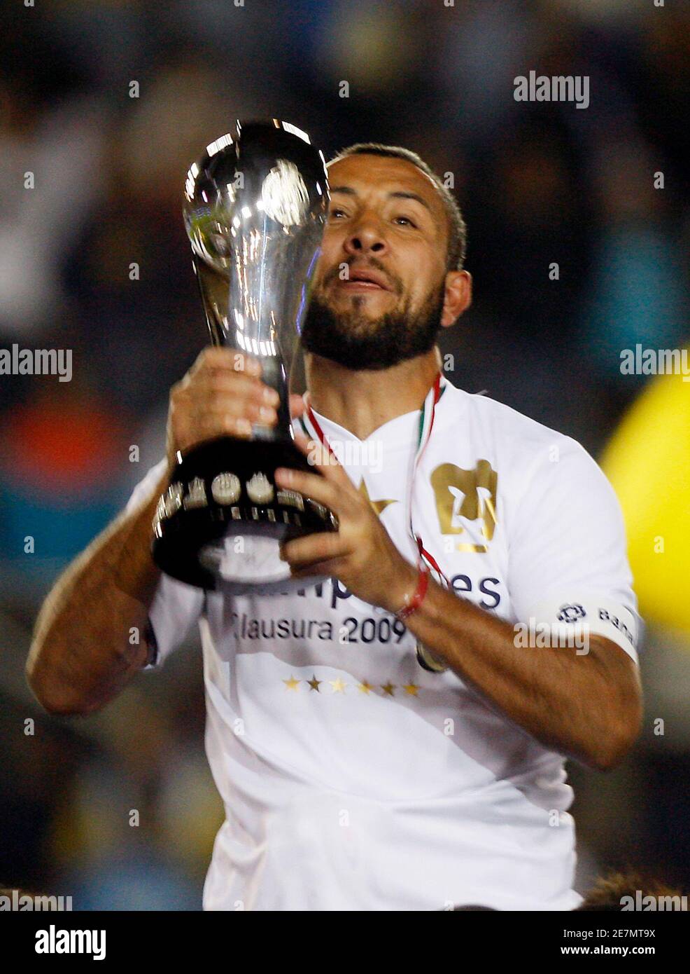 Pumas UNAM captain Sergio Bernal holds the trophy after winning the Mexican  league championship soccer match final against Pachuca at Hidalgo stadium  in Pachuca May 31, 2009. REUTERS/Eliana Aponte (MEXICO SPORT SOCCER