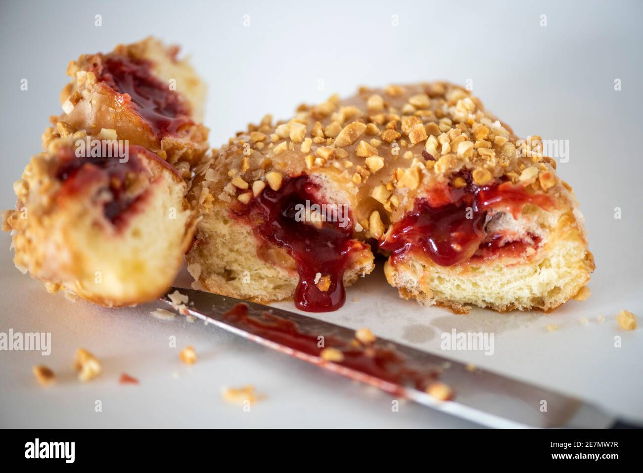 Studio shot of a peanut butter and jelly doughnut with jelly oozing out
