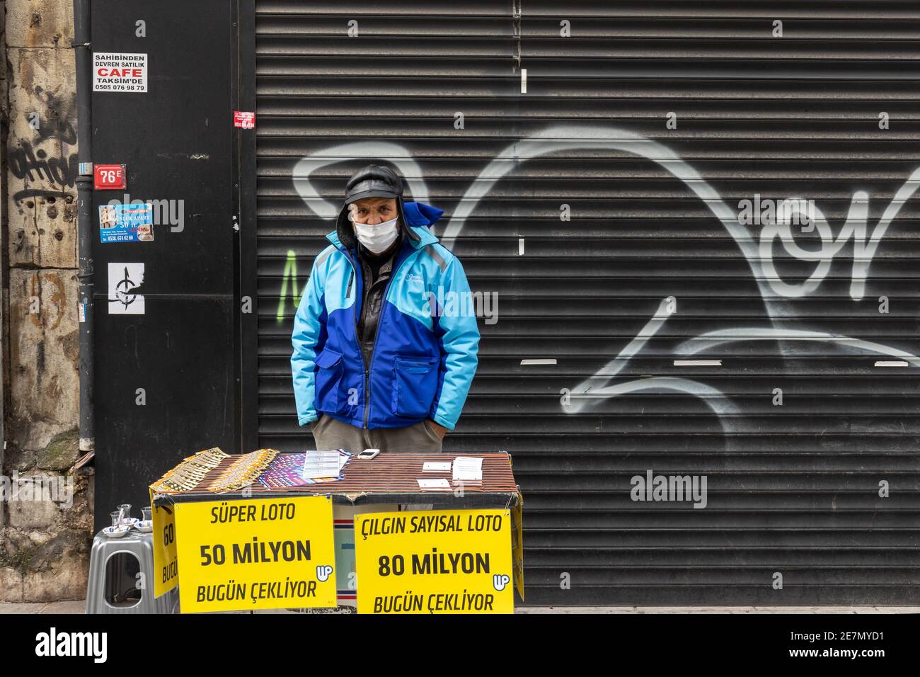 Istanbul, Turkey - Jan. 29, 2021: Man wearing a protective face mask sells lottery ticket in famous Istiklal street in Istanbul. Stock Photo