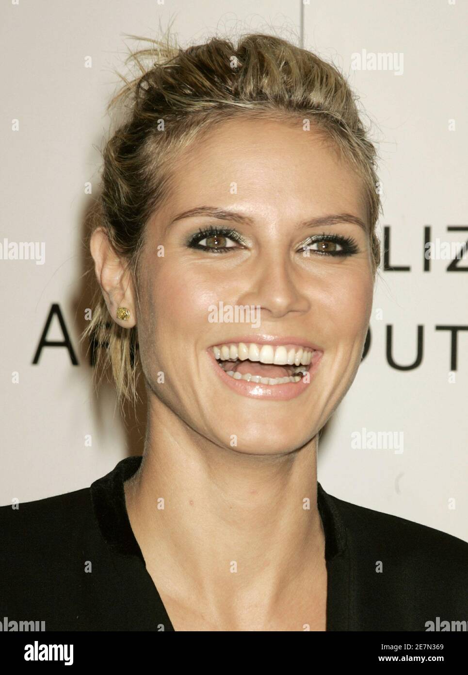 Supermodel Heidi Klum poses as she arrives at a pre-Oscar benefit Vanity Fair's Amped for Africa California benefit in Los Angeles March 2, 2006. [Academy Award nominee for best actress Charlize Theron hosted the event which spotlights the Charlize Theron African Outreach Project benefitting Oprah Winfrey's Angel Network, that helps support vulnerable children and their families in rural South Africa.] Stock Photo