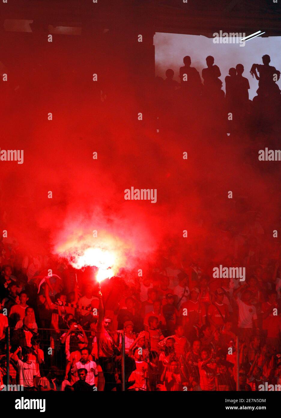 Indonesia supporters celebrate after a goal by Indonesia during the 2007 AFC Asian Cup Group D soccer match against Bahrain in Jakarta July 10, 2007. REUTERS/Beawiharta (INDONESIA) Stock Photo