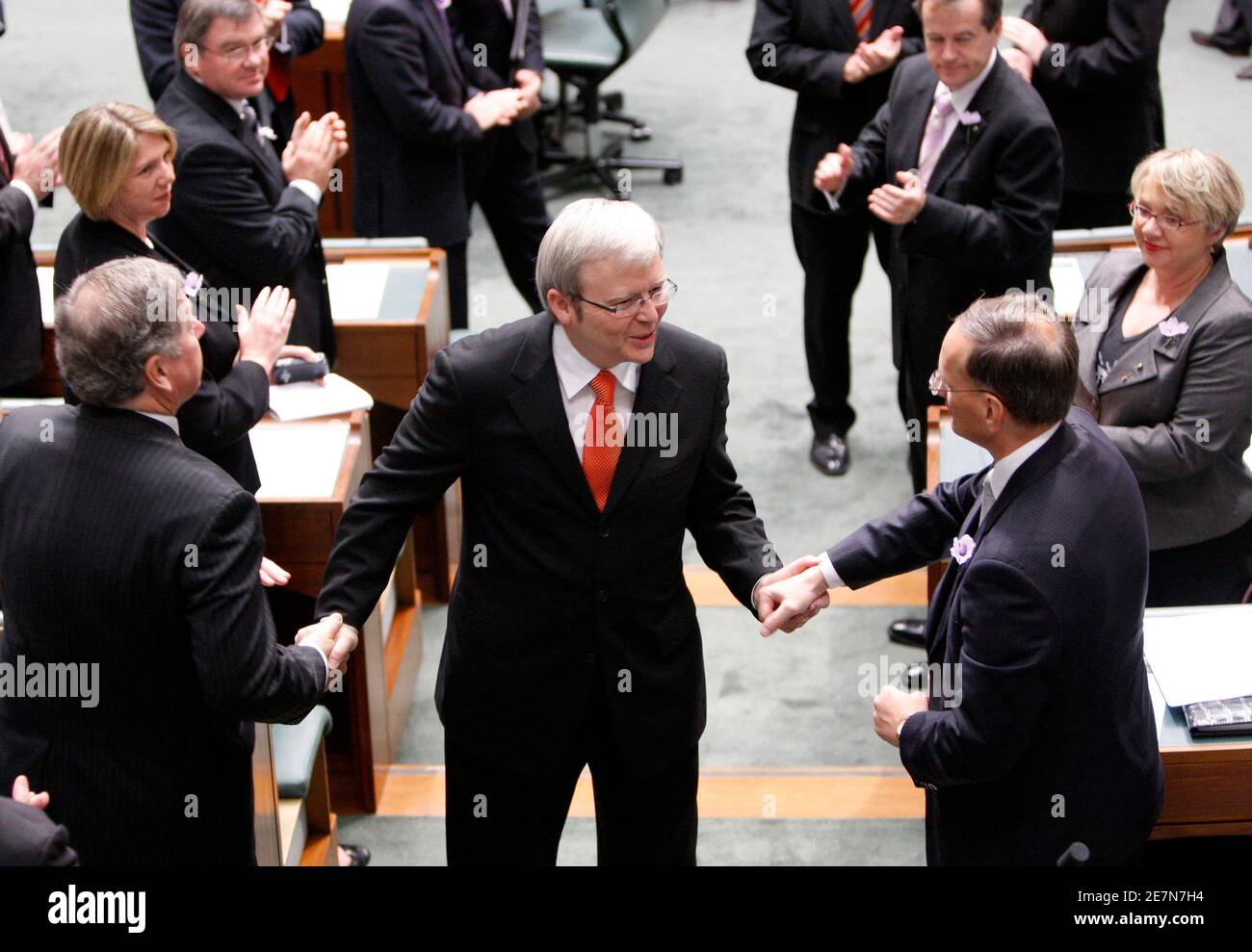 Australian Prime Minister Kevin Rudd (C) is congratulated by members of his  party after delivering an apology speech to the country's indigenous people  in Canberra February 13, 2008. Australia apologised for the