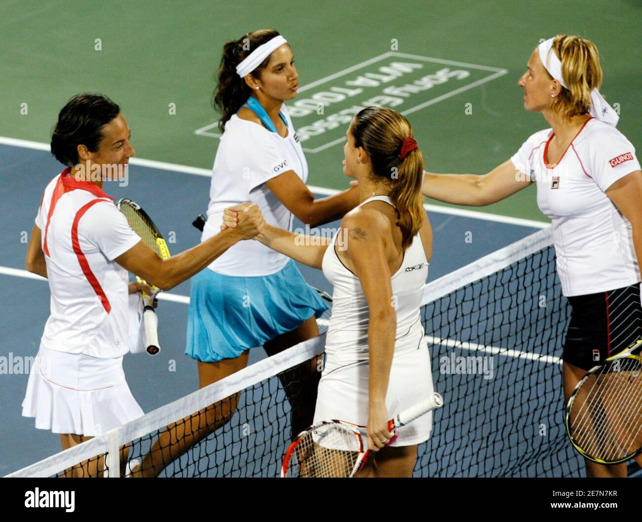 India's Sania Mirza and team mate Francesca Schiavone from Italy(L) shake hands with Russia's Svetlana Kuznetsova(front right) and Amelie Mauresmo of France(front) after their women's doubles match on the first day of the WTA Dubai Tennis Championships February 25, 2008. REUTERS/Jumana El Heloueh (UNITED ARAB EMIRATES) Stock Photo