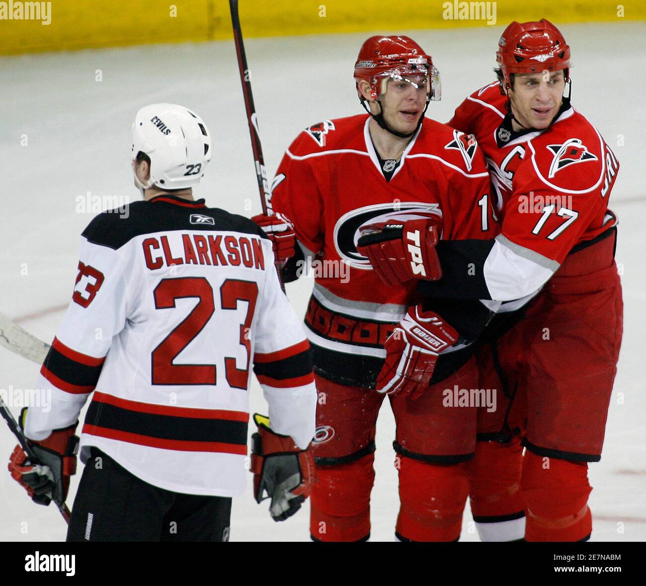 Carolina Hurricanes' Rod Brind'Amour (R) and Sergei Samsonov (C) react  following Samsonov's third period goal against New Jersey Devils as the  Devils' David Clarkson skates past during their NHL hockey game in