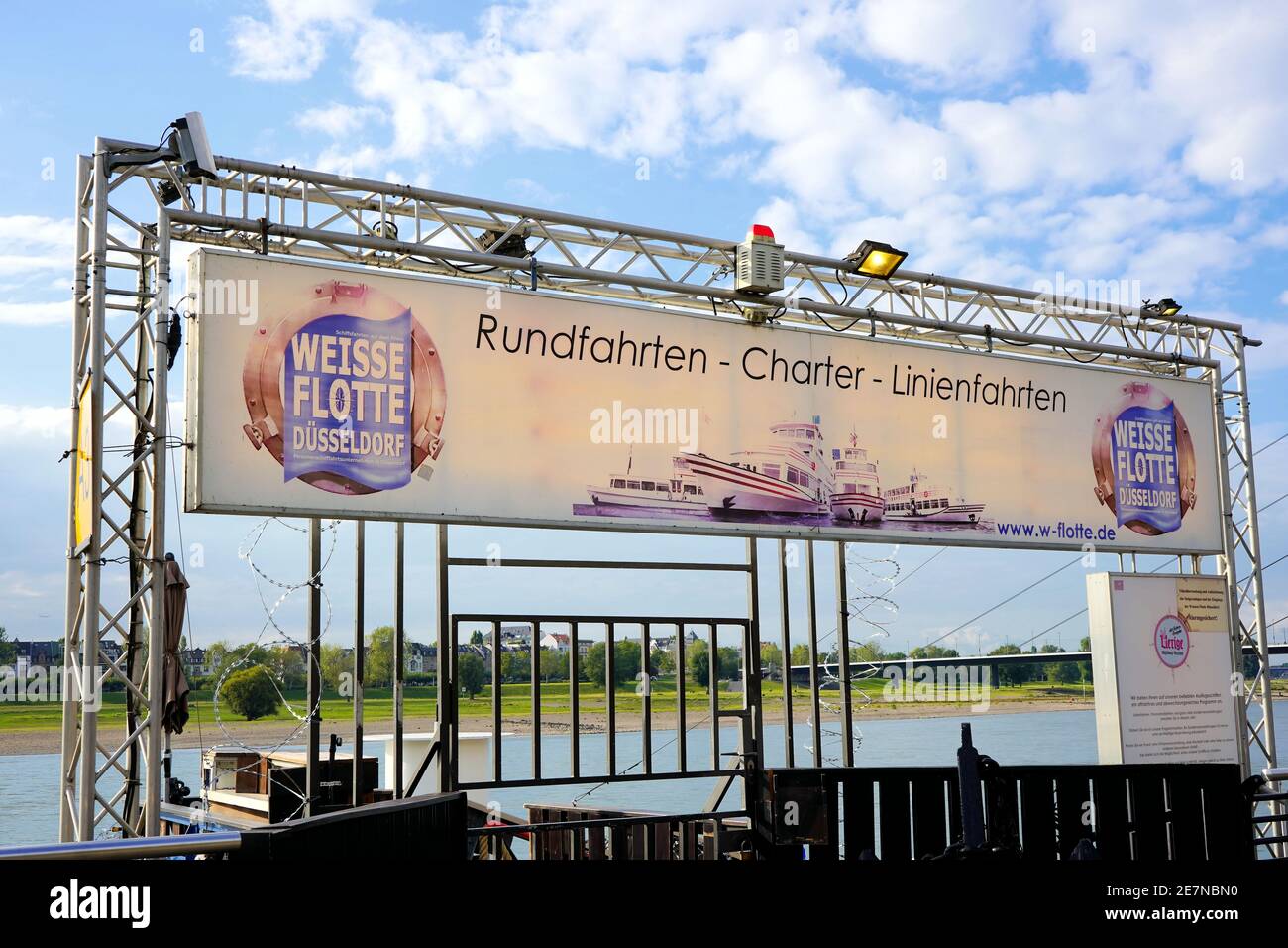 'Weisse Flotte' cruise ship advertisement at the Rhine river promenade on a beautiful sunny day. Stock Photo