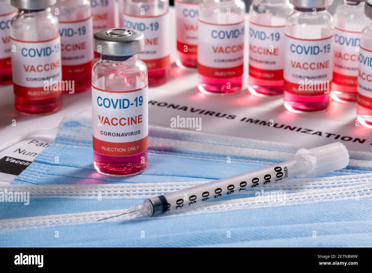 Vaccine vial, syringe and many glass bottles on background for vaccination  Stock Photo