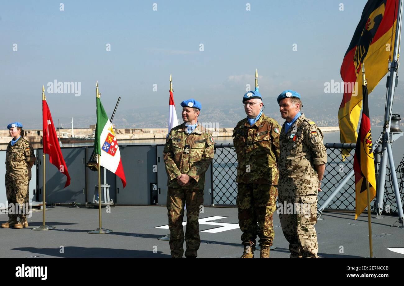 United Nations Interim Force in Lebanon (UNIFIL) Commander Claudio Graziano  (C), Germany?s Rear Admiral Juergen Mannhardt (R) and Rear Admiral Paolo  Sandalli of Italy watch during a handover ceremony aboard German flagship